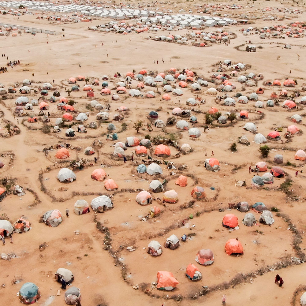Aerial view of a displacement camp in an arid landscape