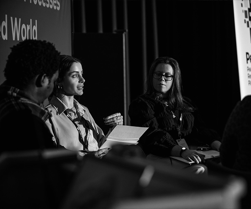 Elisa D’Amico speaking on a panel at a PeaceRep conference